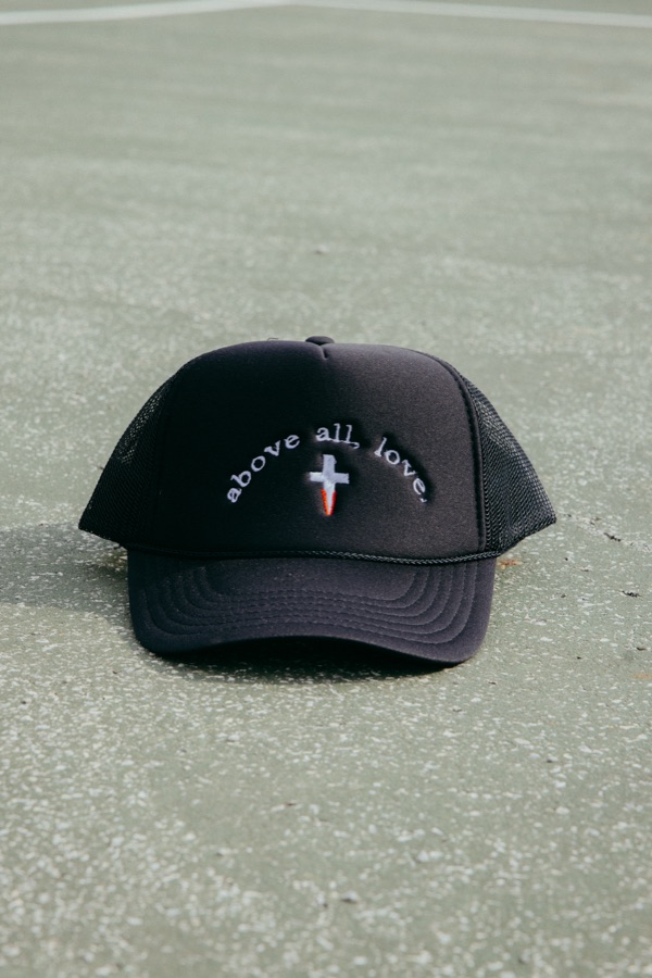 The black Above All Love trucker hat